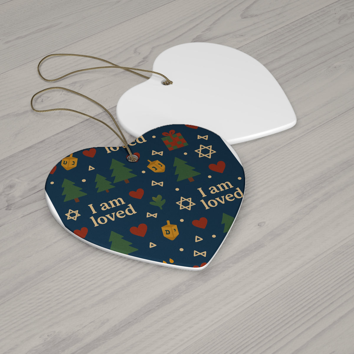 I Am Loved ceramic affirmation ornament hanging on a Christmas tree