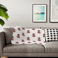 I Am Loved sherpa blanket with a repeating pattern of children hugging and hearts on cream