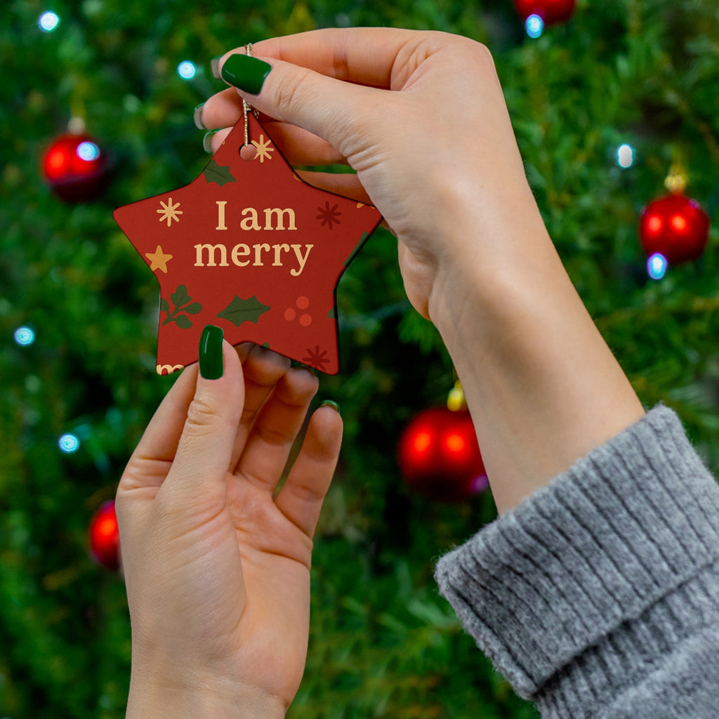 I Am Merry red gingerbread ceramic affirmation ornament hanging on a Christmas tree